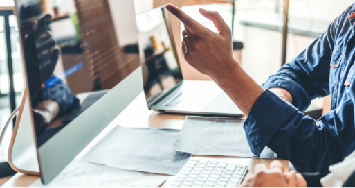 Person pointing to computer monitor